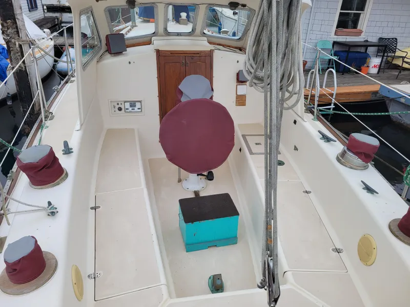 Slide: The Image of 1967 Spencer 42 sailboat cockpit with covered equipment and ropes. - 42
