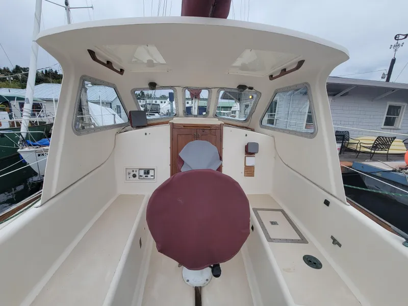 Slide: The Image of 1967 Spencer 42 boat cockpit with covered seats and navigation equipment. - 44
