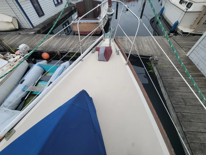 Slide: The Image of Bow of 1967 Spencer 42 sailboat docked at marina, surrounded by other boats. - 9