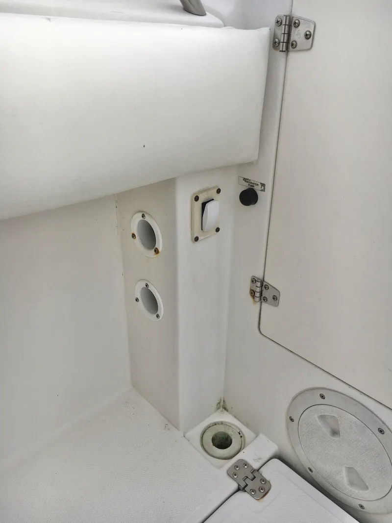 Slide: The Image of 2006 Seaswirl Striper 2901 Walkaround O/B interior details, featuring drainage and storage compartments. - 18