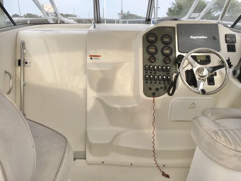 Slide: The Image of 2006 Seaswirl Striper 2901 Walkaround O/B helm with steering wheel and control panel. - 21