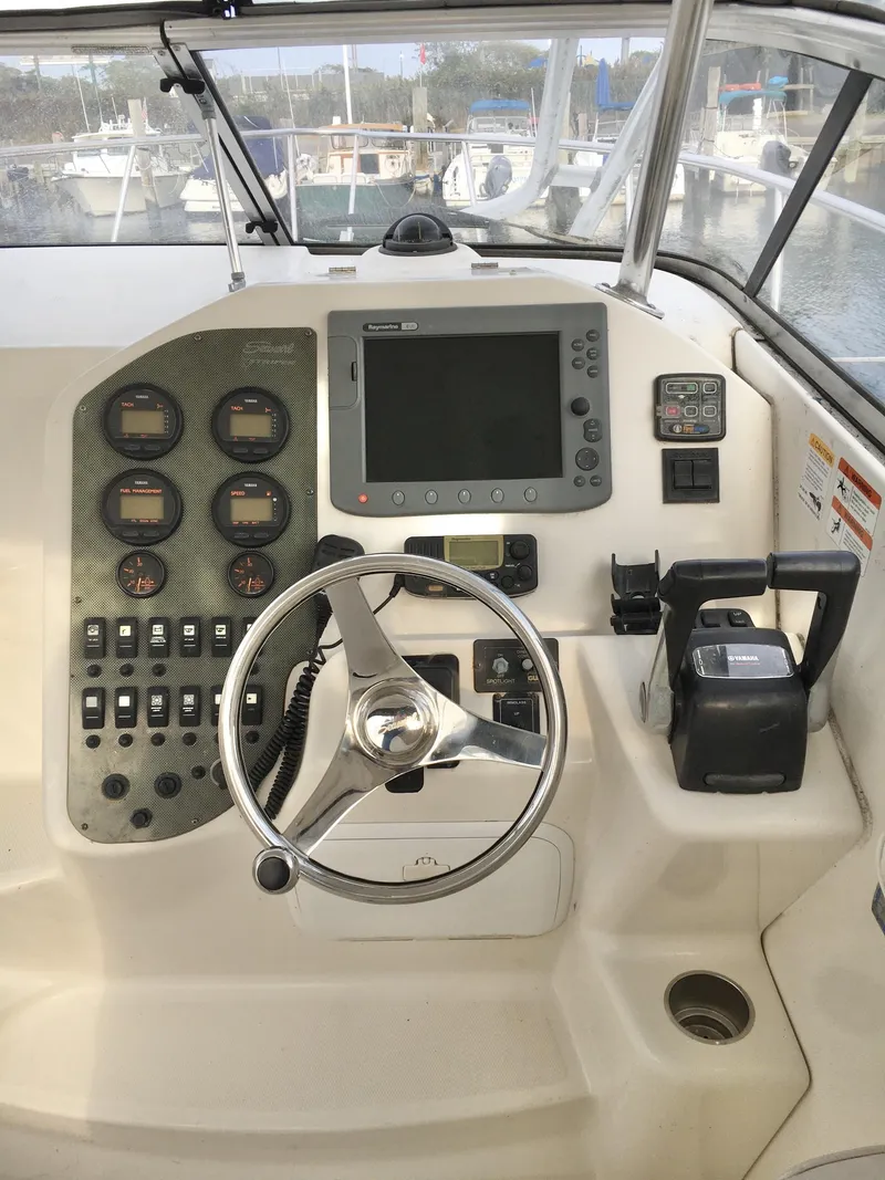 Slide: The Image of 2006 Seaswirl Striper 2901 Walkaround O/B helm with steering wheel and navigation controls. - 22