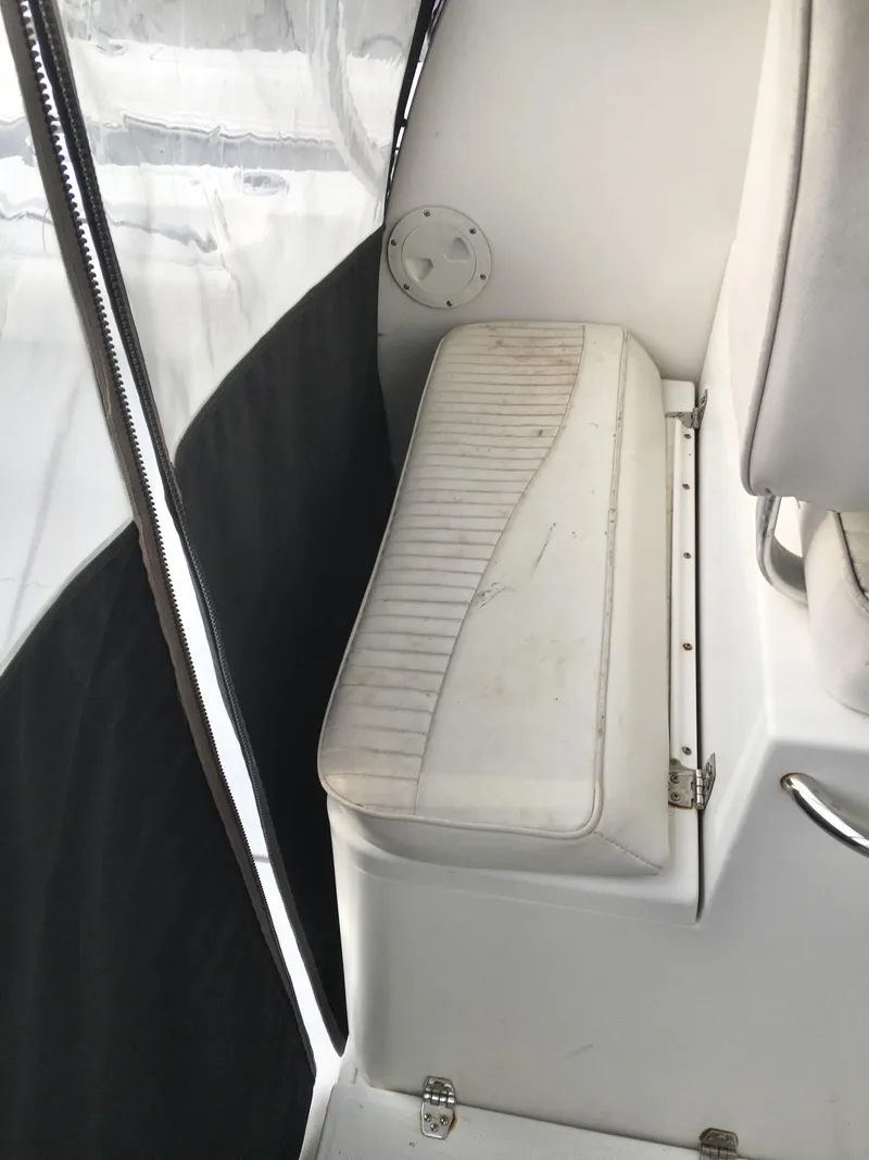 Slide: The Image of 2006 Seaswirl Striper 2901 Walkaround O/B interior seating with white upholstery. - 26