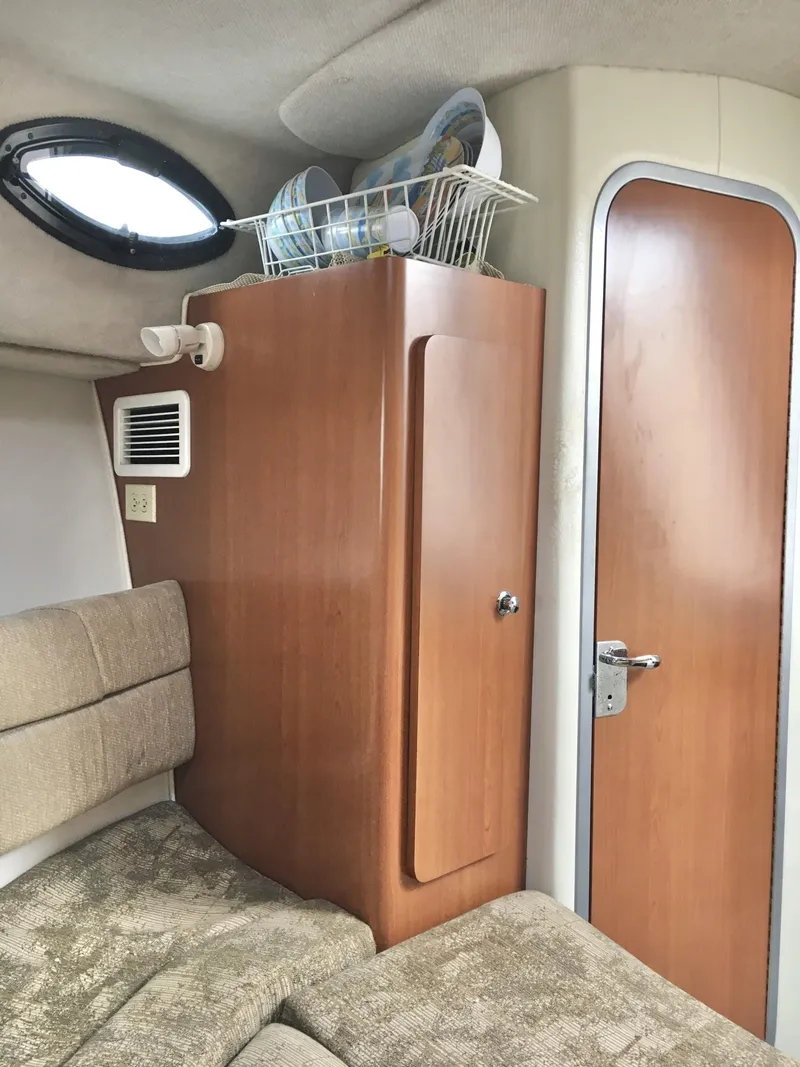 Slide: The Image of 2006 Seaswirl Striper 2901 Walkaround O/B cabin interior with wood paneling and seating. - 32
