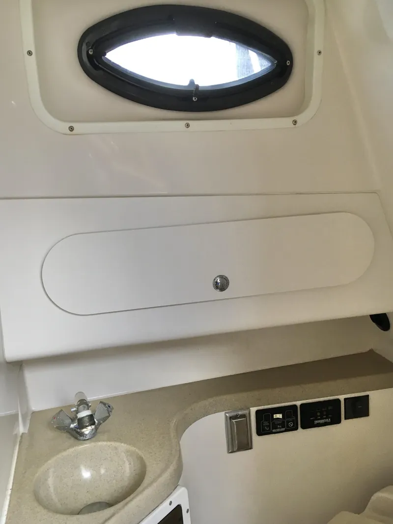Slide: The Image of 2006 Seaswirl Striper 2901 Walkaround O/B cabin interior with sink and control panel. - 34