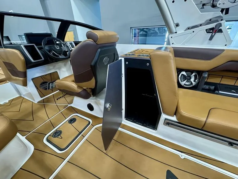 Slide: The Image of Interior of 2021 Malibu 25 LSV boat with tan and brown seating. - 16