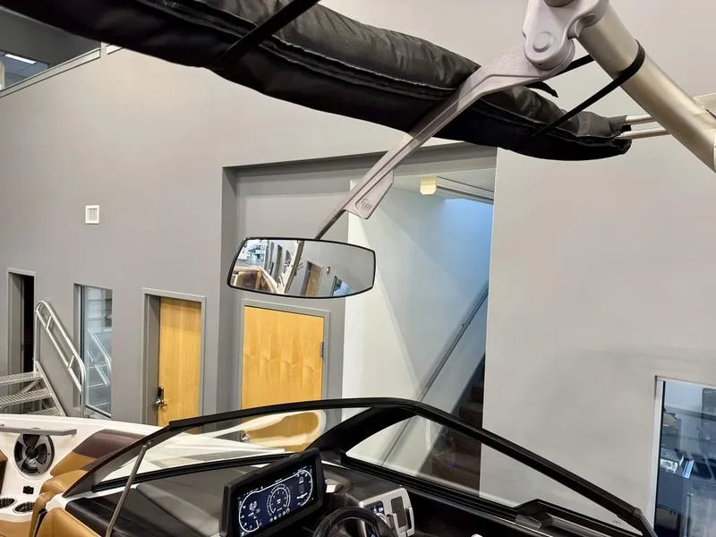 Slide: The Image of 2021 Malibu 25 LSV boat interior with dashboard and mirror. - 20