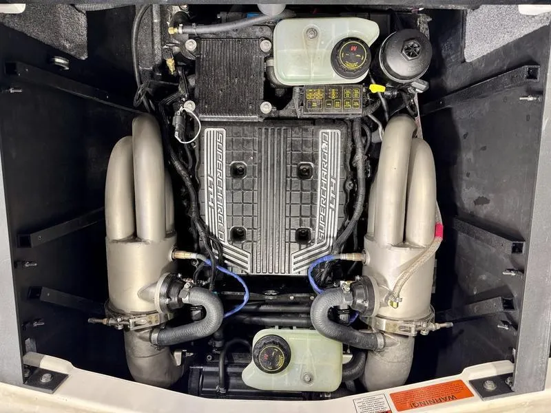 Slide: The Image of 2021 Malibu 25 LSV engine compartment with visible components and hoses. - 21
