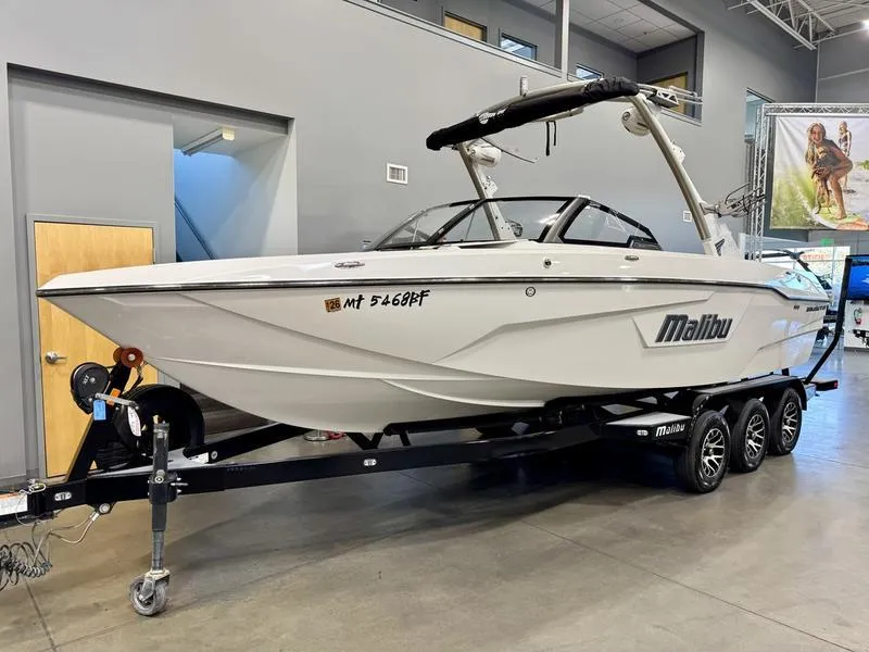 Slide: The Image of 2021 Malibu 25 LSV boat on trailer in showroom. - 4