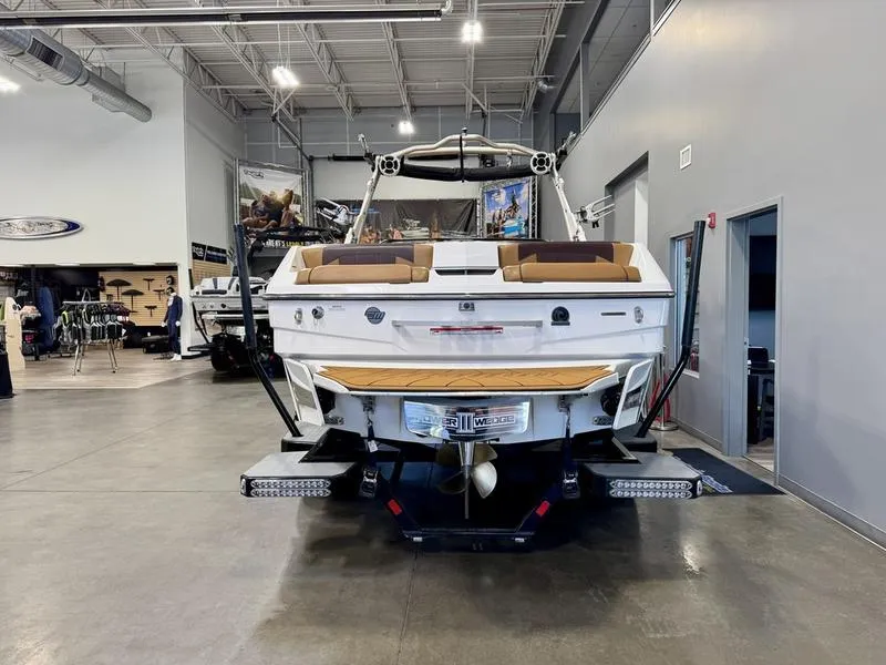 Slide: The Image of 2021 Malibu 25 LSV boat in showroom, rear view. - 5