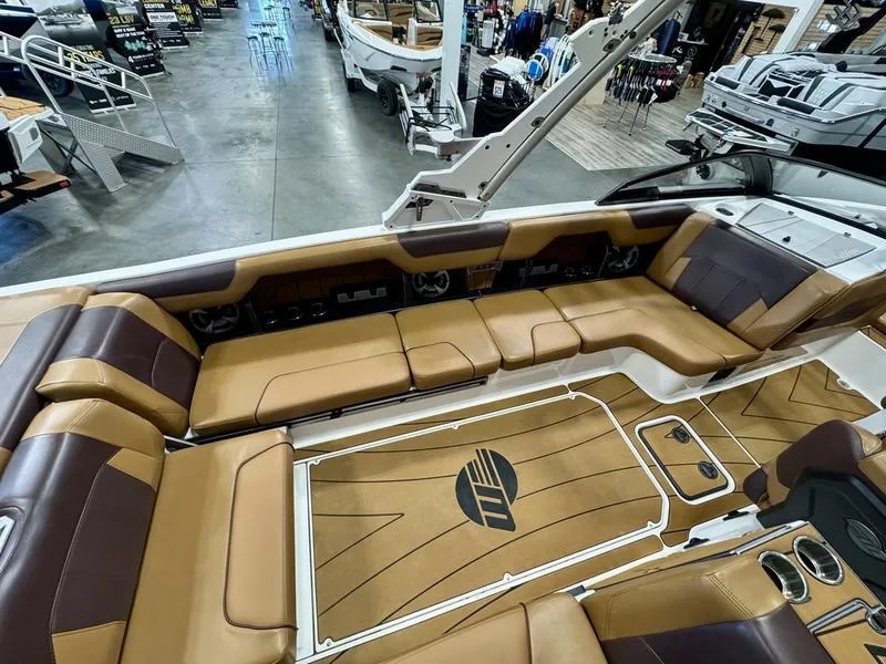 Slide: The Image of 2021 Malibu 25 LSV boat interior with tan leather seating and spacious layout. - 6