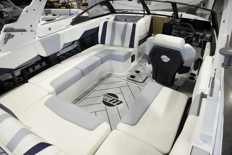 Slide: The Image of 2025 Malibu 22 LSV boat interior with modern seating and sleek design. - 14