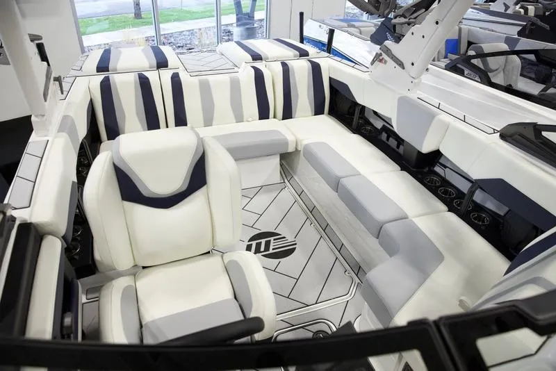 Slide: The Image of 2025 Malibu 22 LSV boat interior with modern seating and sleek design. - 16