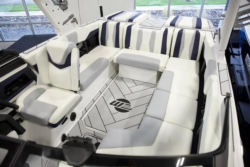 Slide: The Image of 2025 Malibu 22 LSV boat interior with luxurious white and gray seating. - 17