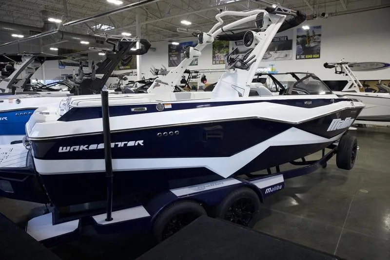 Slide: The Image of 2025 Malibu 22 LSV boat displayed in showroom, featuring sleek design and modern features. - 4