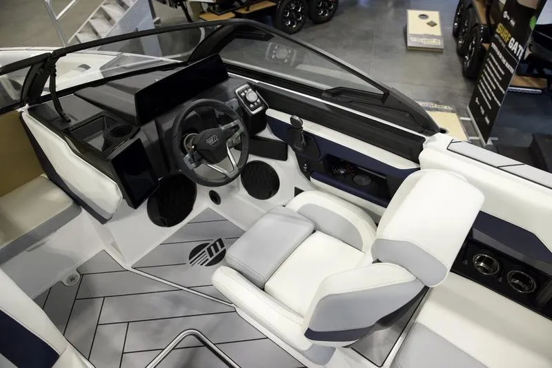 Slide: The Image of 2025 Malibu 22 LSV boat interior with modern dashboard and seating. - 9