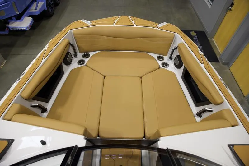 Slide: The Image of 2024 Axis A245 boat interior with tan seating and cup holders. - 12