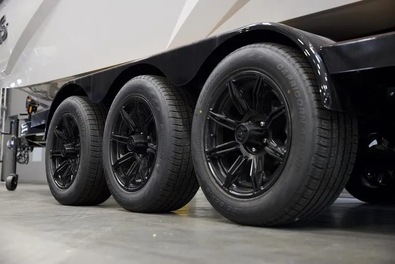 Slide: The Image of 2024 Axis A245 trailer with three black wheels on display. - 13