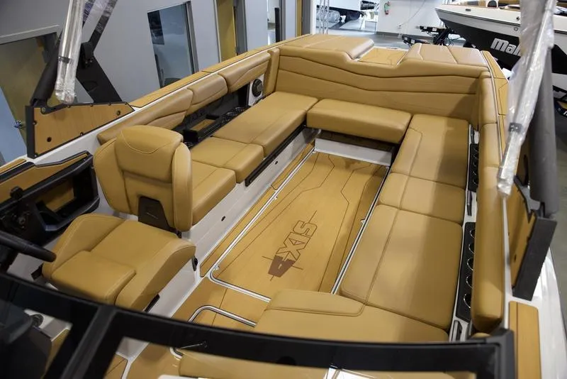 Slide: The Image of 2024 Axis A245 boat interior with tan seating and spacious layout. - 17