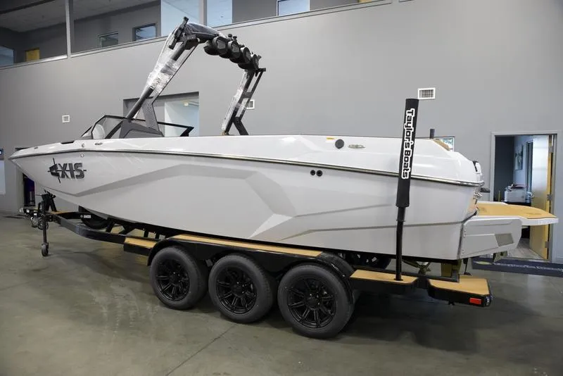 Slide: The Image of 2024 Axis A245 boat on trailer in showroom, side view. - 18