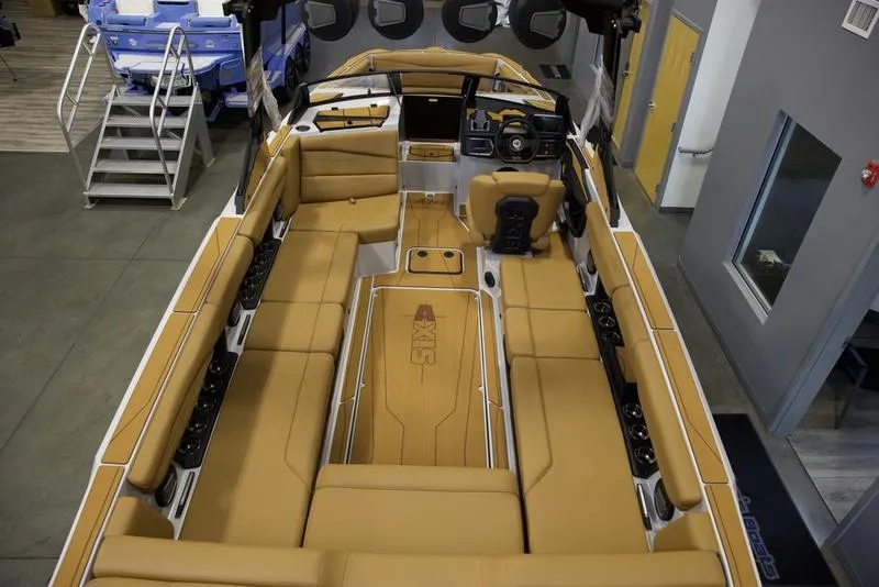 Slide: The Image of 2024 Axis A245 boat interior with tan seating and modern dashboard. - 19