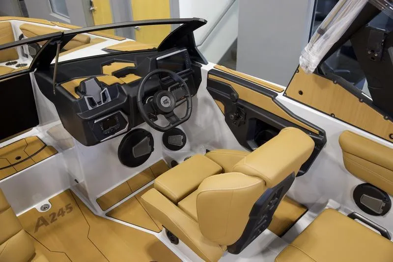 Slide: The Image of 2024 Axis A245 boat interior with tan seats and modern dashboard. - 8