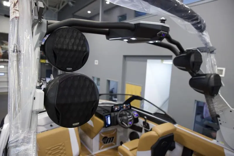 Slide: The Image of 2025 Malibu 26 LSV boat interior with premium audio system and modern dashboard. - 13