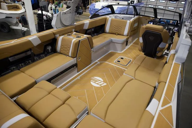 Slide: The Image of Luxurious interior of 2025 Malibu 26 LSV boat with tan seating and modern design. - 18