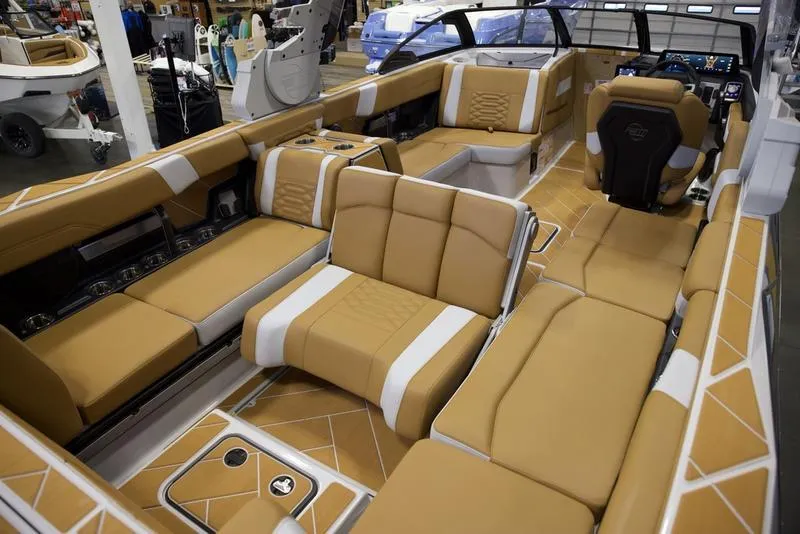 Slide: The Image of Luxurious interior of 2025 Malibu 26 LSV boat with tan seating and modern design. - 20