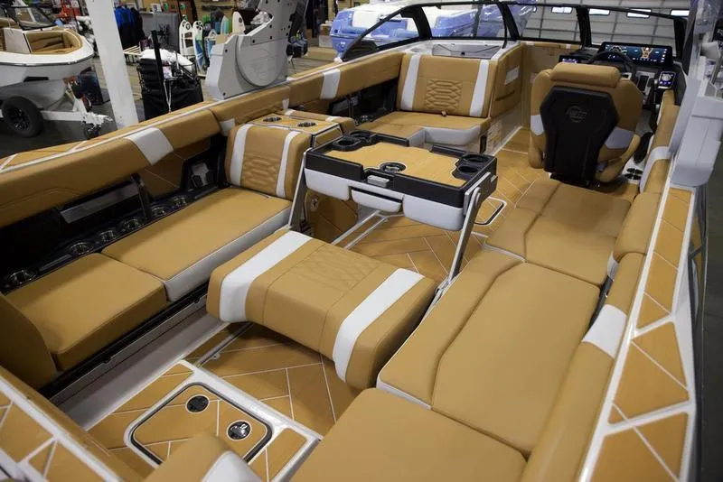 Slide: The Image of Luxurious interior of 2025 Malibu 26 LSV boat with tan seating and modern design. - 21