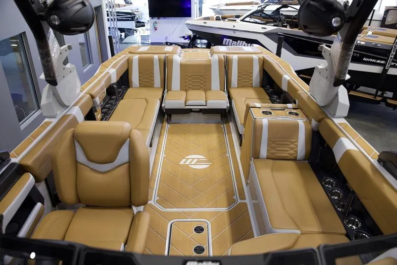 Slide: The Image of Luxurious interior of 2025 Malibu 26 LSV boat with tan leather seating. - 24