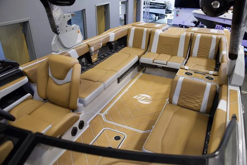 Slide: The Image of Luxurious interior of 2025 Malibu 26 LSV boat with tan seating and modern design. - 25