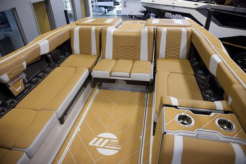 Slide: The Image of Luxurious interior of 2025 Malibu 26 LSV boat with tan and white seating. - 26
