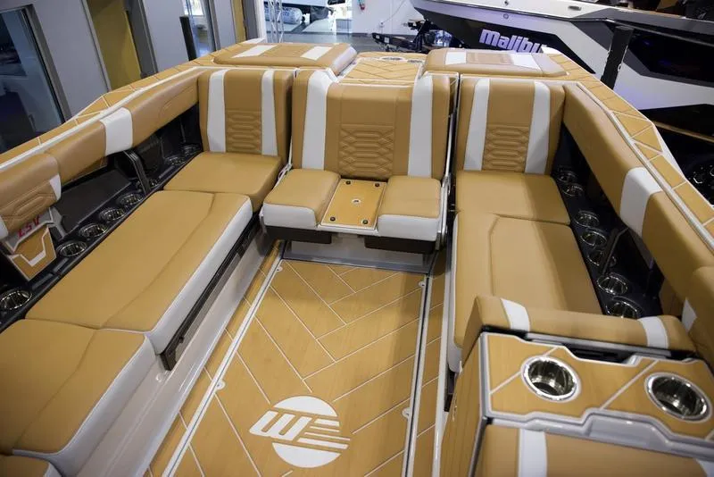Slide: The Image of Luxurious interior of 2025 Malibu 26 LSV boat with tan and white seating. - 28