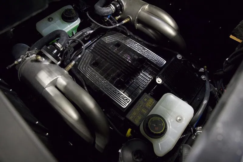 Slide: The Image of 2025 Malibu 26 LSV engine compartment with dual exhaust and fluid reservoirs. - 3