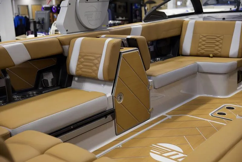 Slide: The Image of Luxurious interior of 2025 Malibu 26 LSV boat with tan and white seating. - 30
