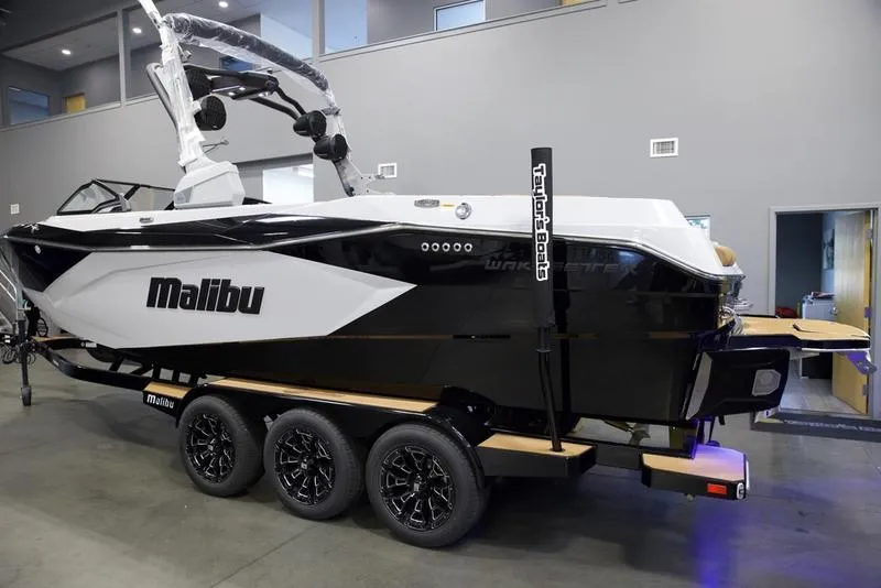Slide: The Image of 2025 Malibu 26 LSV boat on trailer in showroom. - 5