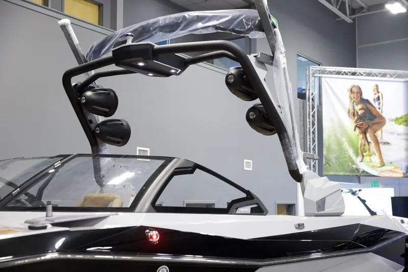 Slide: The Image of 2025 Malibu 26 LSV boat with sleek design and advanced audio system. - 9