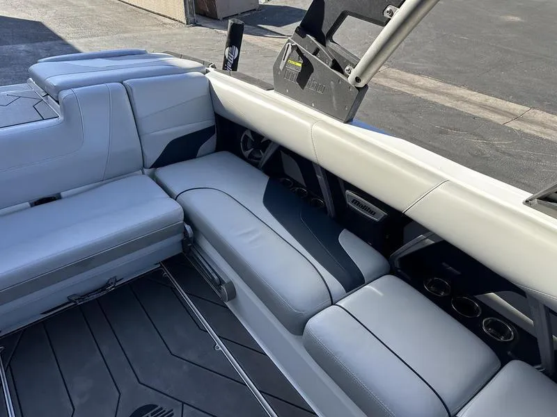 Slide: The Image of 2020 Malibu 22 MXZ boat interior with sleek gray seating and modern design. - 11