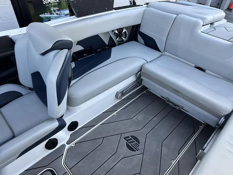 Slide: The Image of 2020 Malibu 22 MXZ boat interior with gray seating and flooring. - 12