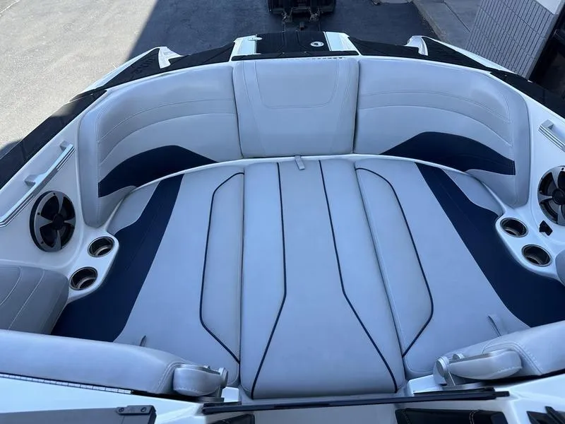 Slide: The Image of 2020 Malibu 22 MXZ boat interior with sleek seating and cup holders. - 14