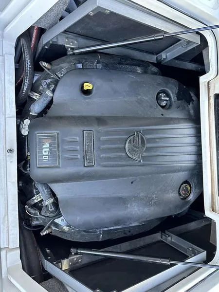 Slide: The Image of 2020 Malibu 22 MXZ engine compartment with visible components and cover. - 15