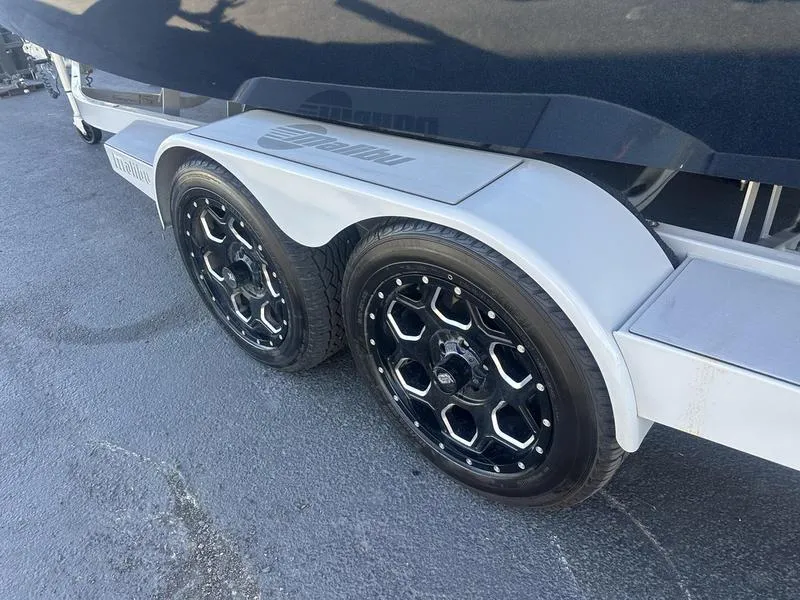 Slide: The Image of 2020 Malibu 22 MXZ trailer with black alloy wheels on pavement. - 5