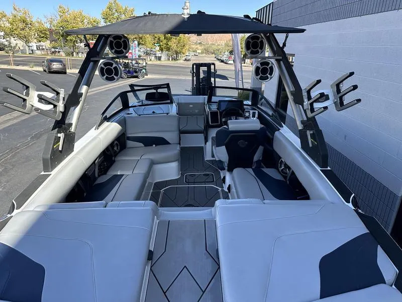Slide: The Image of 2020 Malibu 22 MXZ boat interior with spacious seating and advanced audio system. - 8