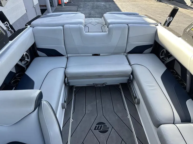 Slide: The Image of 2020 Malibu 22 MXZ boat interior with gray seating and sleek design. - 9