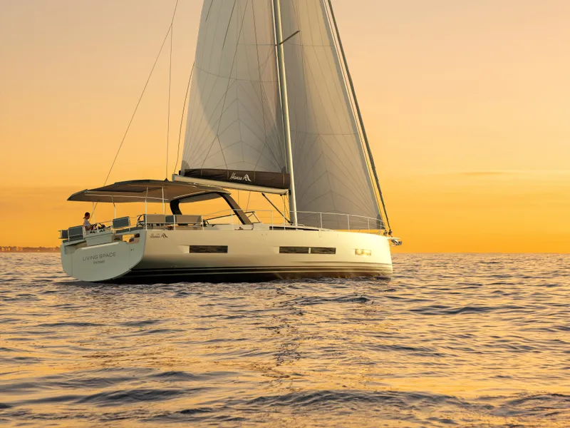 Slide: The Image of Sailing yacht Hanse 590, 2025 model, at sunset on calm waters. - 43