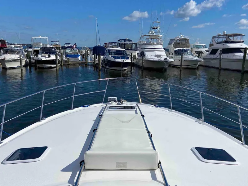 Slide: The Image of Bow view of 2002 Sea Ray 380 Sundancer docked in a marina. - 10