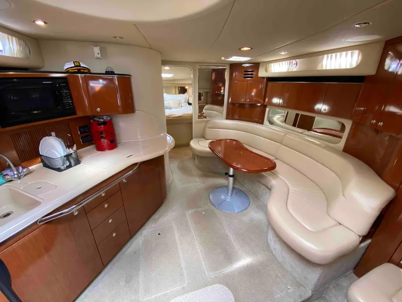 Slide: The Image of Luxurious interior of 2002 Sea Ray 380 Sundancer yacht with modern kitchen and seating area. - 12