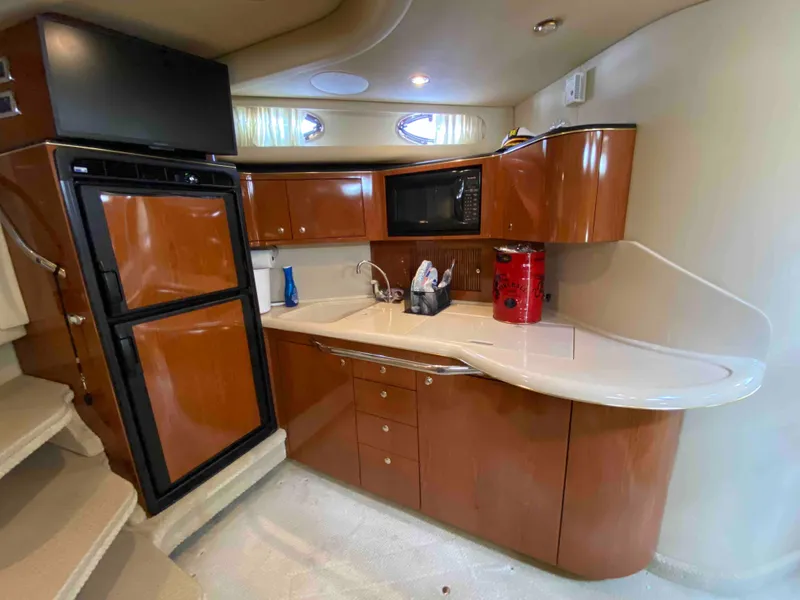 Slide: The Image of Luxurious 2002 Sea Ray 380 Sundancer yacht kitchen with modern amenities. - 15