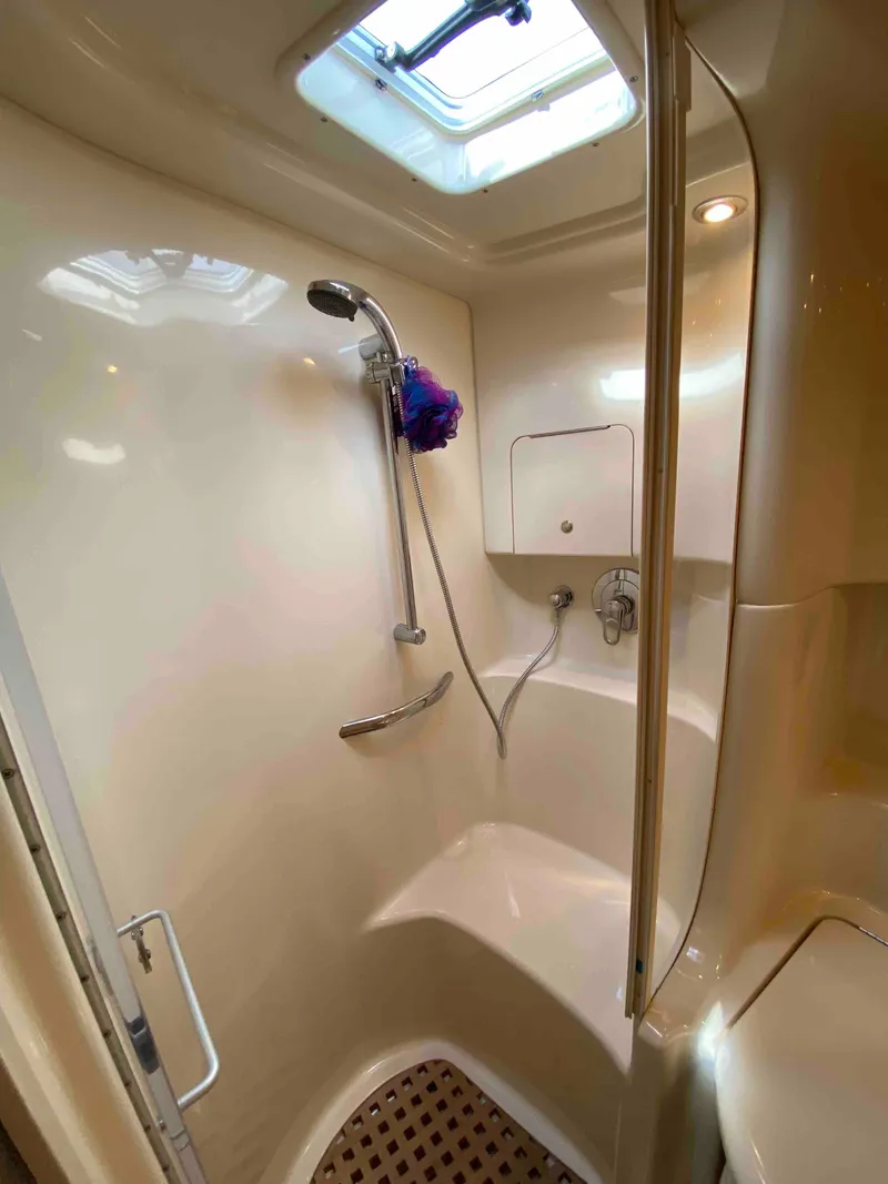 Slide: The Image of 2002 Sea Ray 380 Sundancer shower with skylight and modern fixtures. - 20